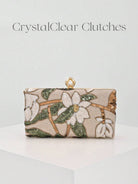 Clutch rigida con motivo floreale verde su fondo avorio e catena dorata