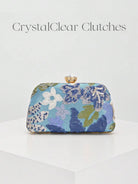 Pochette a mezzaluna con fantasia floreale blu e lilla e catena dorata