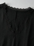 Dettaglio dello scollo a V con volant del vestito nero