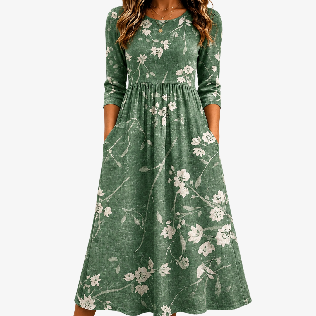 Abito midi verde con stampa floreale, linea rilassata e tasche laterali