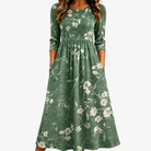 Abito midi verde con stampa floreale, linea rilassata e tasche laterali